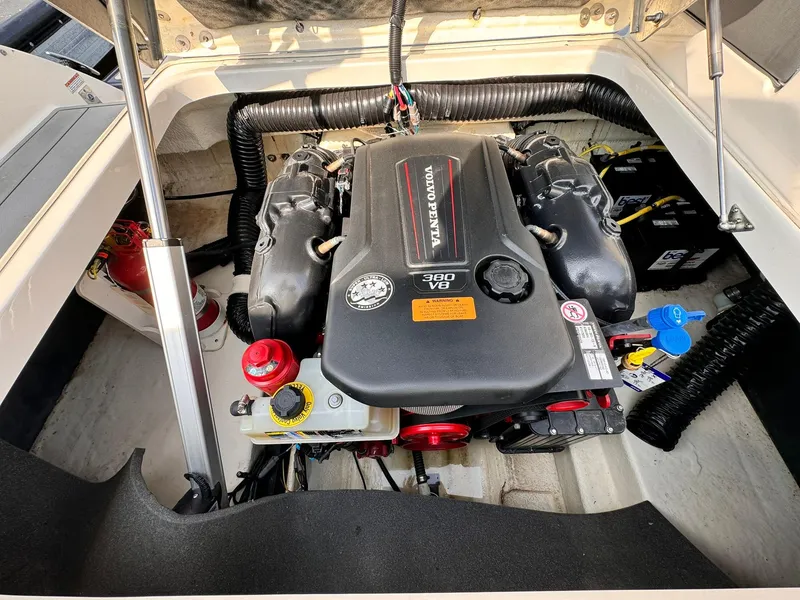Slide: The Image of Engine compartment of a 2021 Chaparral 307 SSX boat, featuring a Volvo Penta V8 engine. - 26