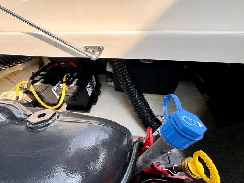 Slide: The Image of Engine compartment of 2021 Chaparral 307 SSX boat, showing battery and engine components. - 27