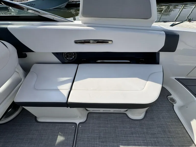 Slide: The Image of 2021 Chaparral 307 SSX boat interior seating with sleek white and black design. - 29