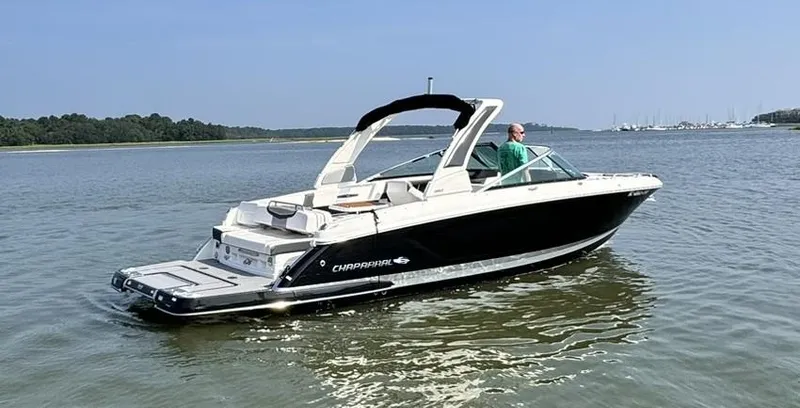 Slide: The Image of 2021 Chaparral 307 SSX boat on calm water, featuring sleek design and modern amenities. - 3