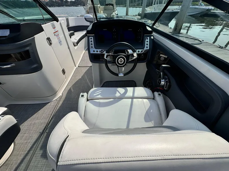 Slide: The Image of 2021 Chaparral 307 SSX boat interior with modern steering and dashboard controls. - 31