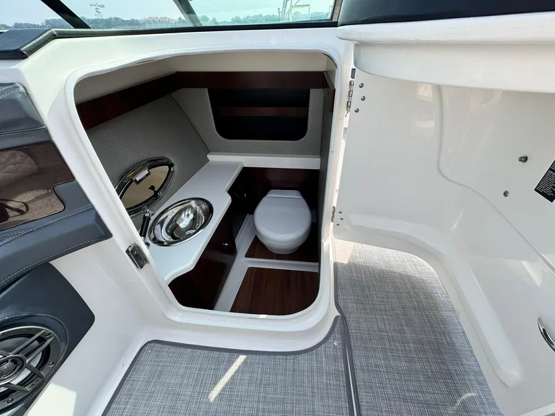 Slide: The Image of 2021 Chaparral 307 SSX boat interior with compact bathroom and modern fixtures. - 35