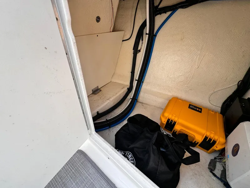 Slide: The Image of Interior of 2021 Chaparral 307 SSX boat with storage area and equipment. - 38