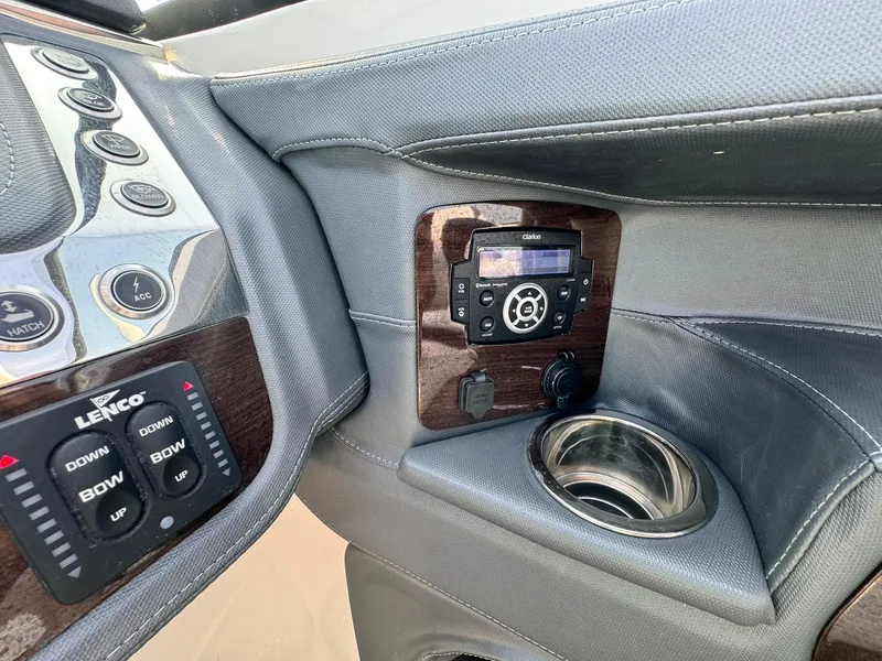 Slide: The Image of Control panel of 2021 Chaparral 307 SSX boat with audio system and cup holder. - 40