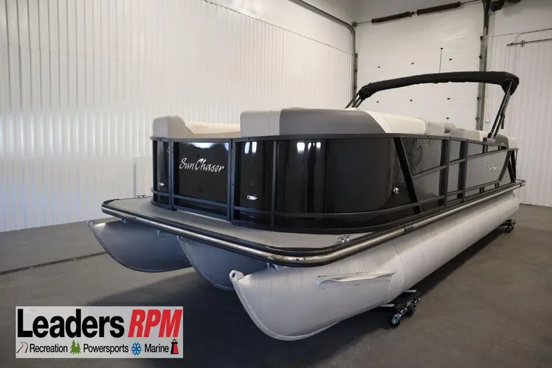 Slide: The Image of 2021 SunChaser 23 SBX Eclipse Tri-Toon boat in indoor showroom setting. - 1