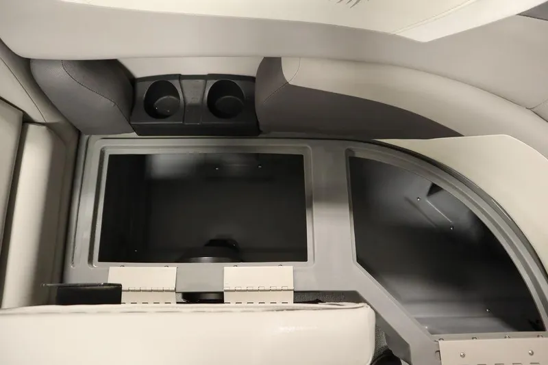 Slide: The Image of Interior of 2021 SunChaser 23 SBX Eclipse Tri-Toon, featuring storage compartments and cup holders. - 13