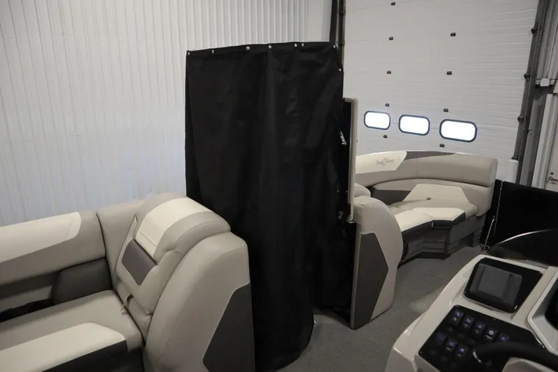 Slide: The Image of 2021 SunChaser 23 SBX Eclipse Tri-Toon interior with seating and privacy curtain. - 17