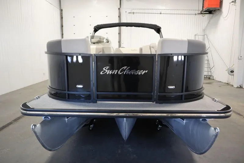 Slide: The Image of 2021 SunChaser 23 SBX Eclipse Tri-Toon boat in a showroom, front view. - 2