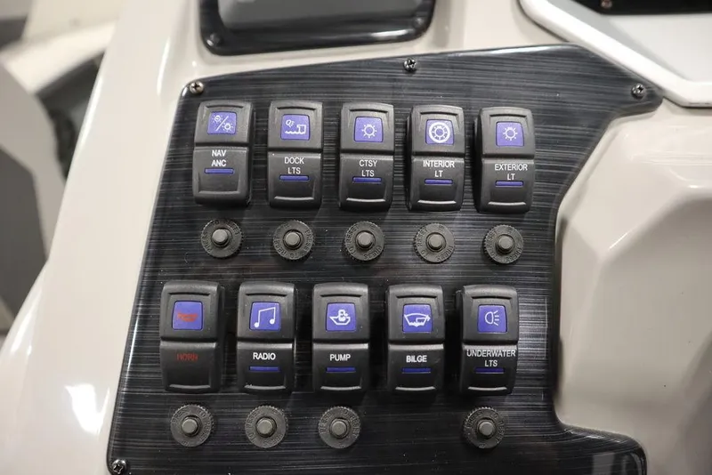 Slide: The Image of Control panel of 2021 SunChaser 23 SBX Eclipse Tri-Toon with labeled switches. - 26