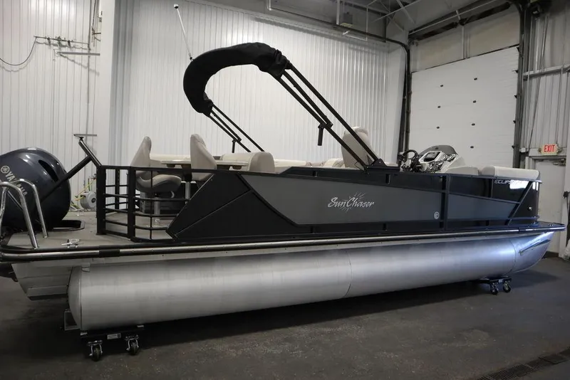 Slide: The Image of 2021 SunChaser 23 SBX Eclipse Tri-Toon boat in indoor storage facility. - 4