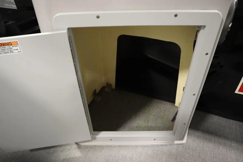 Slide: The Image of Open storage compartment on 2021 SunChaser 23 SBX Eclipse Tri-Toon boat. - 45