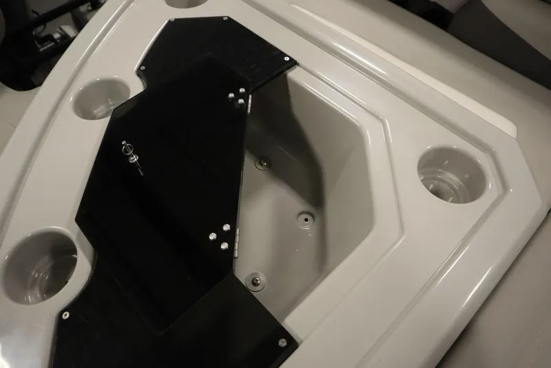 Slide: The Image of 2021 SunChaser 23 SBX Eclipse Tri-Toon boat interior with cup holders and storage compartment. - 47