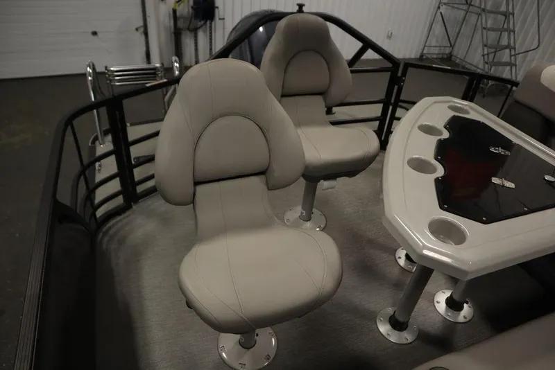 Slide: The Image of 2021 SunChaser 23 SBX Eclipse Tri-Toon interior with beige seats and table. - 48