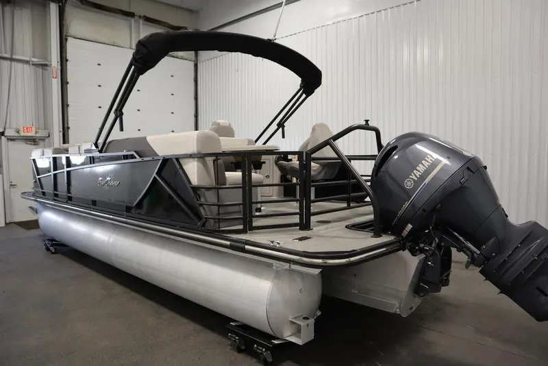 Slide: The Image of 2021 SunChaser 23 SBX Eclipse Tri-Toon boat with Yamaha outboard motor in a garage. - 6