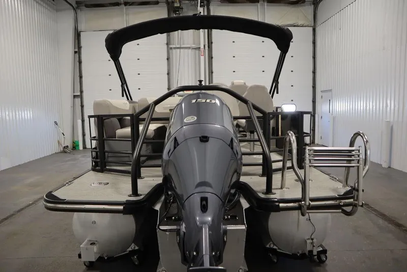 Slide: The Image of 2021 SunChaser 23 SBX Eclipse Tri-Toon boat in a storage facility. - 7