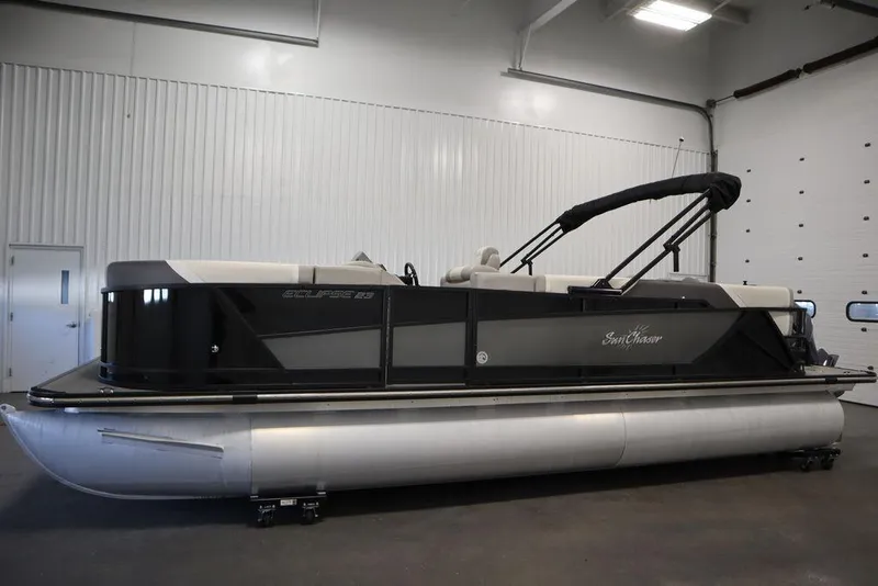 Slide: The Image of 2021 SunChaser 23 SBX Eclipse Tri-Toon boat in indoor storage facility. - 8