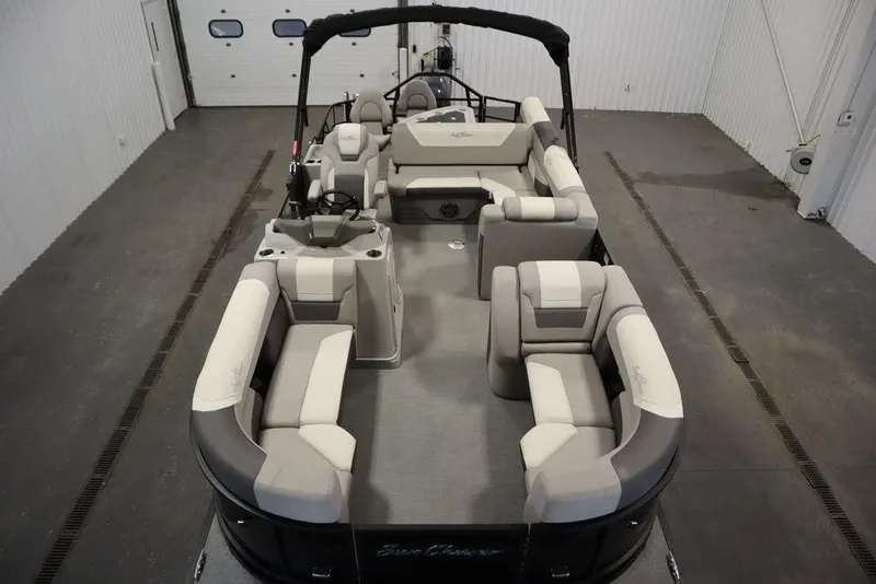 Slide: The Image of 2021 SunChaser 23 SBX Eclipse Tri-Toon boat with spacious seating in a showroom. - 9