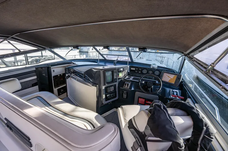 Slide: The Image of Interior view of 1991 Sea Ray 420 Sundancer yacht cockpit with steering wheel and navigation equipment. - 10