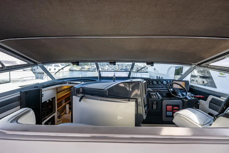 Slide: The Image of Interior view of 1991 Sea Ray 420 Sundancer yacht cockpit with helm and seating. - 11