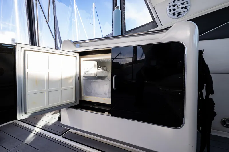 Slide: The Image of 1991 Sea Ray 420 Sundancer yacht interior with open mini fridge. - 12