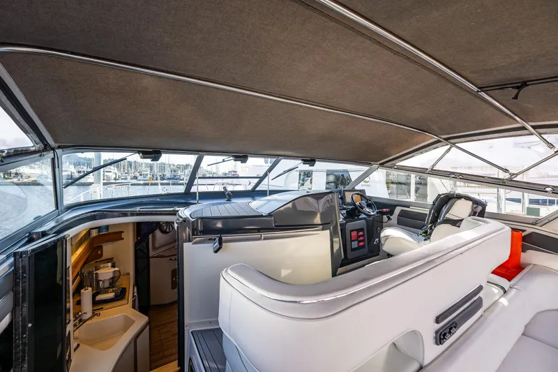 Slide: The Image of Interior view of 1991 Sea Ray 420 Sundancer yacht with helm and seating area. - 14