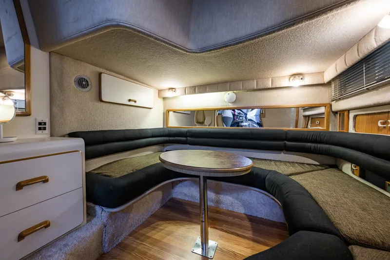 Slide: The Image of Interior of 1991 Sea Ray 420 Sundancer with cozy seating and wooden table. - 17