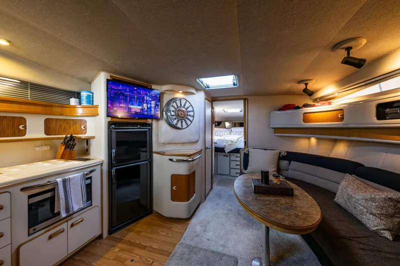 Slide: The Image of Interior of 1991 Sea Ray 420 Sundancer yacht with kitchen, seating, and modern amenities. - 21