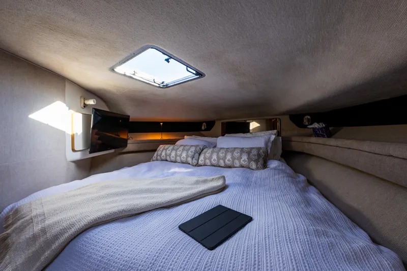 Slide: The Image of Cozy cabin interior of 1991 Sea Ray 420 Sundancer with bed and skylight. - 26