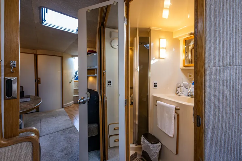 Slide: The Image of Interior of 1991 Sea Ray 420 Sundancer yacht, featuring bathroom and cabin area. - 27