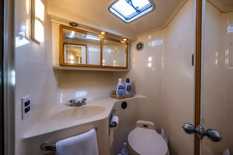 Slide: The Image of Luxurious bathroom in 1991 Sea Ray 420 Sundancer yacht with modern amenities. - 30