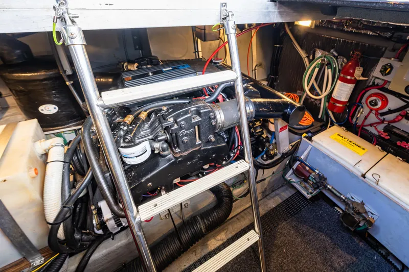 Slide: The Image of Engine room of 1991 Sea Ray 420 Sundancer with visible machinery and equipment. - 35