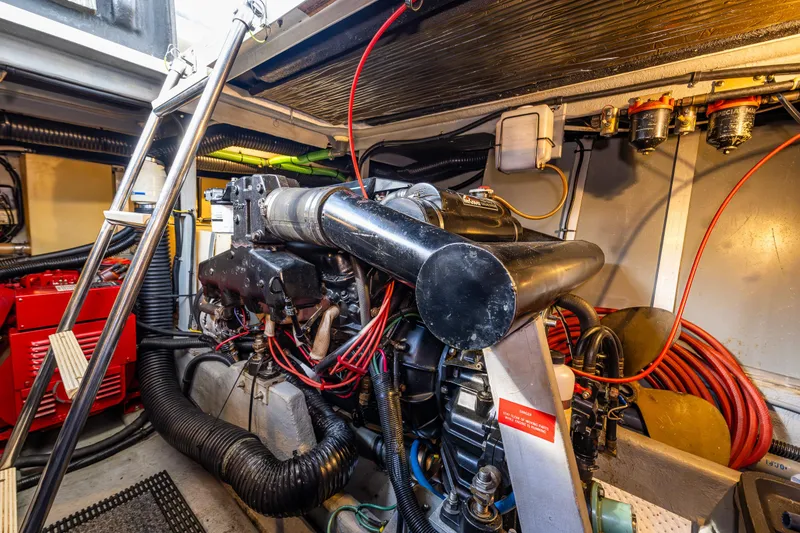 Slide: The Image of Engine room of a 1991 Sea Ray 420 Sundancer, showcasing mechanical components and wiring. - 36