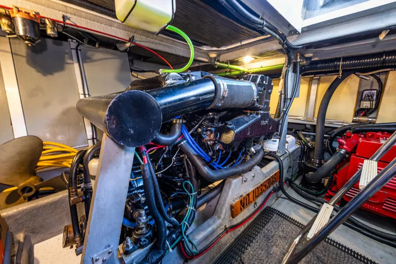 Slide: The Image of Engine room of a 1991 Sea Ray 420 Sundancer, showcasing detailed mechanical components. - 38