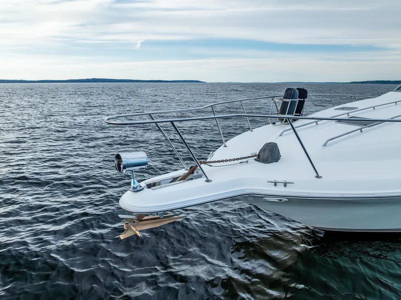 Slide: The Image of Sea Ray 420 Sundancer 1991 yacht on calm waters under a cloudy sky. - 6