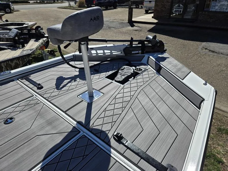 Slide: The Image of 2025 Avid 20 Vertex boat deck with Minn Kota trolling motor and textured flooring. - 10