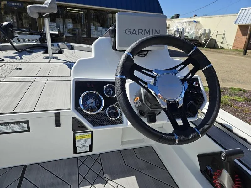 Slide: The Image of 2025 Avid 20 Vertex boat dashboard with Garmin navigation and modern steering wheel. - 16