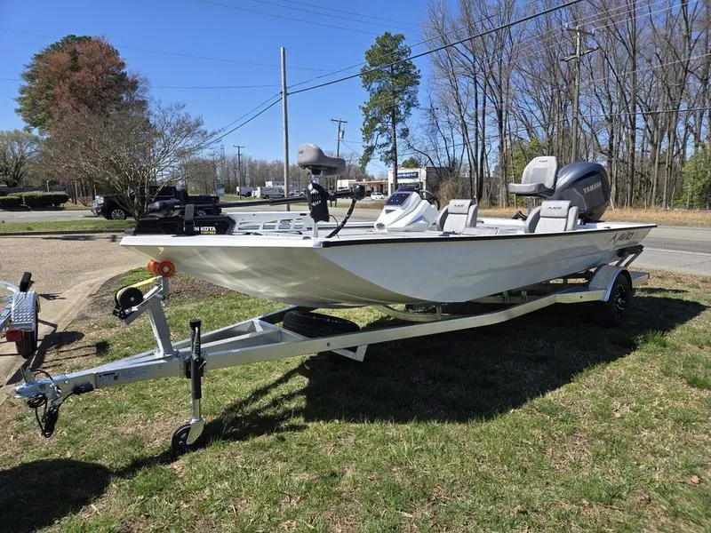 Slide: The Image of 2025 Avid 20 Vertex boat on trailer, parked outdoors, surrounded by trees and grass. - 5