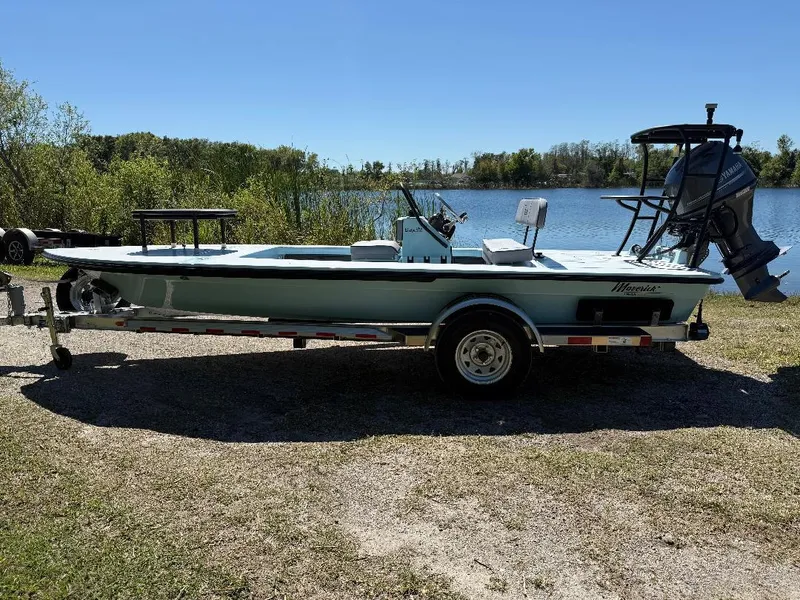 Slide: The Image of 2025 Maverick HPX 17 HPX-S boat on trailer by a lake, under clear blue sky. - 10