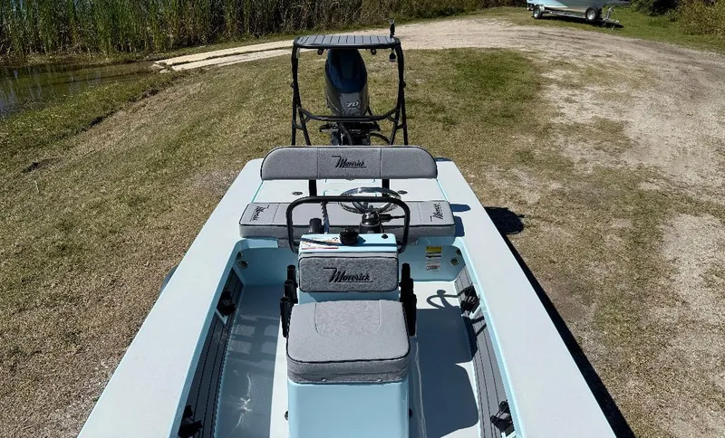 Slide: The Image of 2025 Maverick HPX 17 HPX-S boat on grassy terrain, showcasing seating and console. - 15