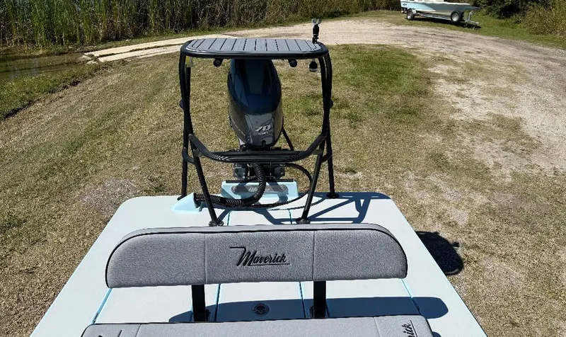 Slide: The Image of 2025 Maverick HPX 17 HPX-S boat with motor, parked on grassy terrain. - 17