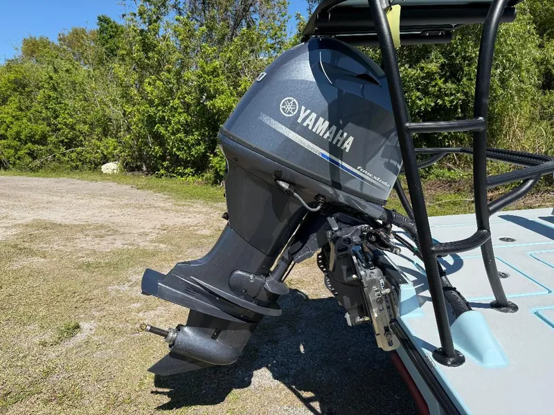 Slide: The Image of Yamaha outboard motor on 2025 Maverick HPX 17 HPX-S boat, parked on grassy area. - 9