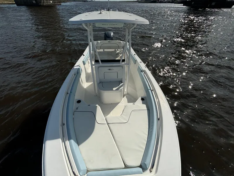 Slide: The Image of 2014 Sea Hunt Ultra 234 boat on water, featuring spacious deck and seating. - 17