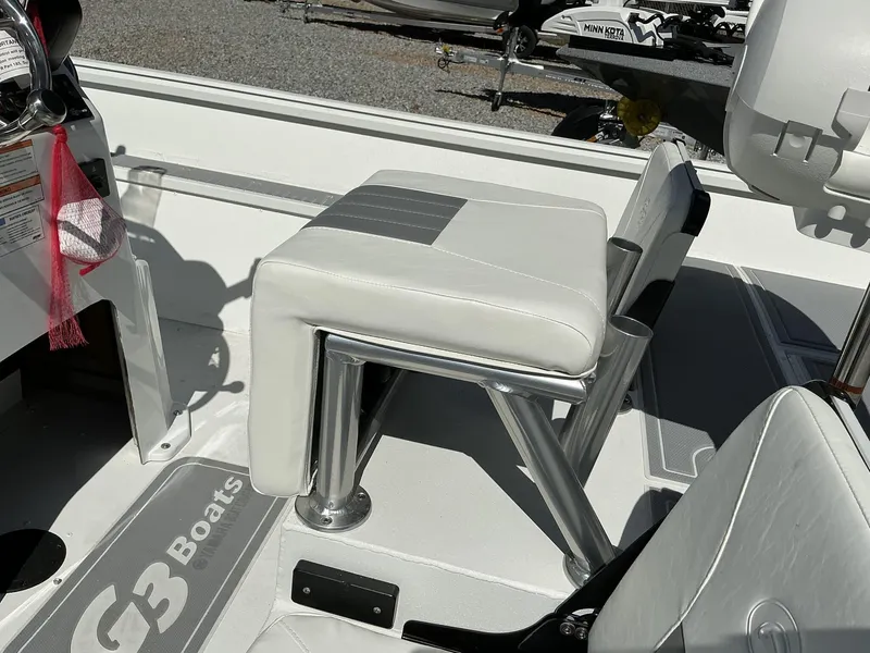 Slide: The Image of 2025 G3 Bay 20 boat interior with white seating and steering wheel. - 10