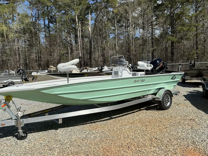 Slide: The Image of 2025 G3 Bay 20 boat on trailer, parked outdoors, surrounded by trees. - 3
