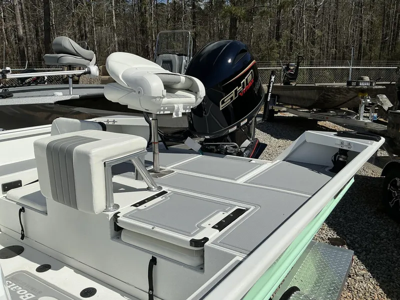 Slide: The Image of 2025 G3 Bay 20 boat with seating and powerful outboard motor in a wooded area. - 4