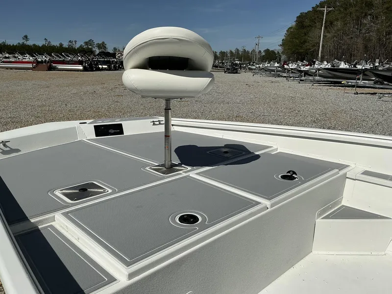 Slide: The Image of 2025 G3 Bay 20 boat deck with seating and storage compartments in a gravel lot. - 6