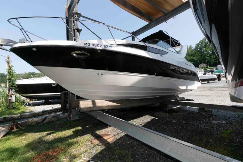 The Image of 2008 Bayliner 285 boat on trailer in outdoor storage area. - 0