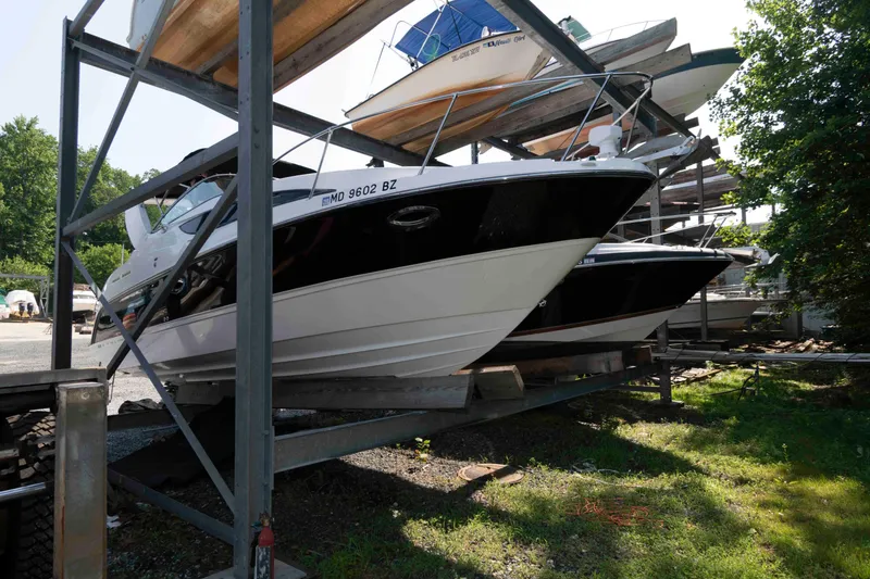 Slide: The Image of 2008 Bayliner 285 boat stored on a rack in a marina. - 1