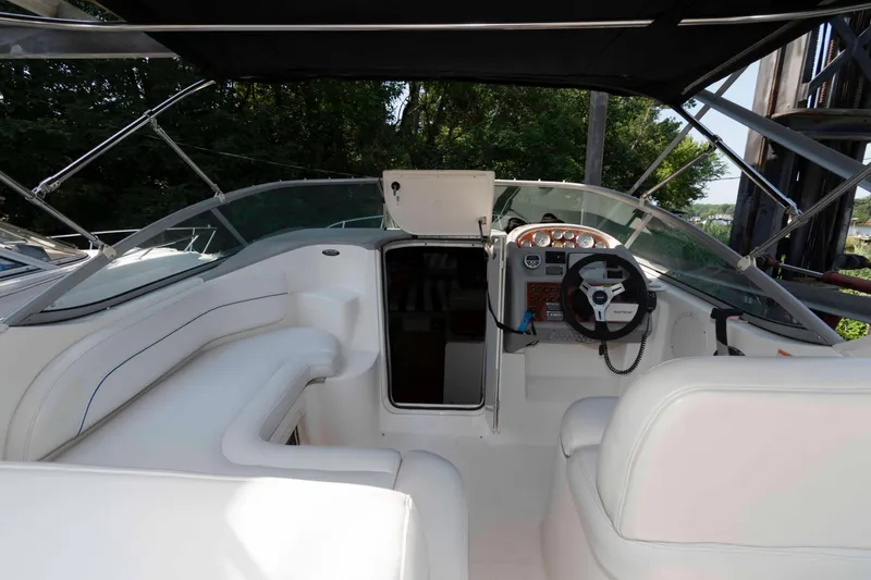 Slide: The Image of 2008 Bayliner 285 boat cockpit with steering wheel and seating area. - 12