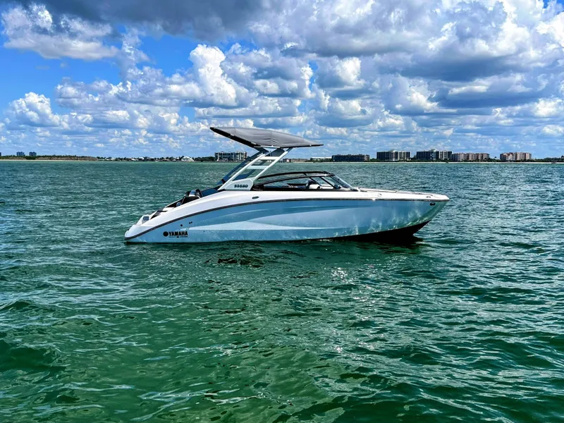 The Image of 2023 Yamaha Boats 252SD on open water under a partly cloudy sky. - 1